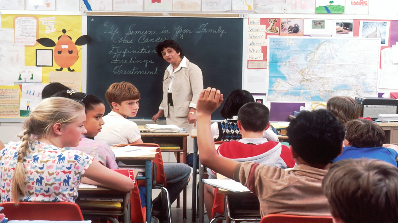 A classroom student raising his hand to answer the teacher while peers watch, contrasting classic participation with a random name generator wheel.
