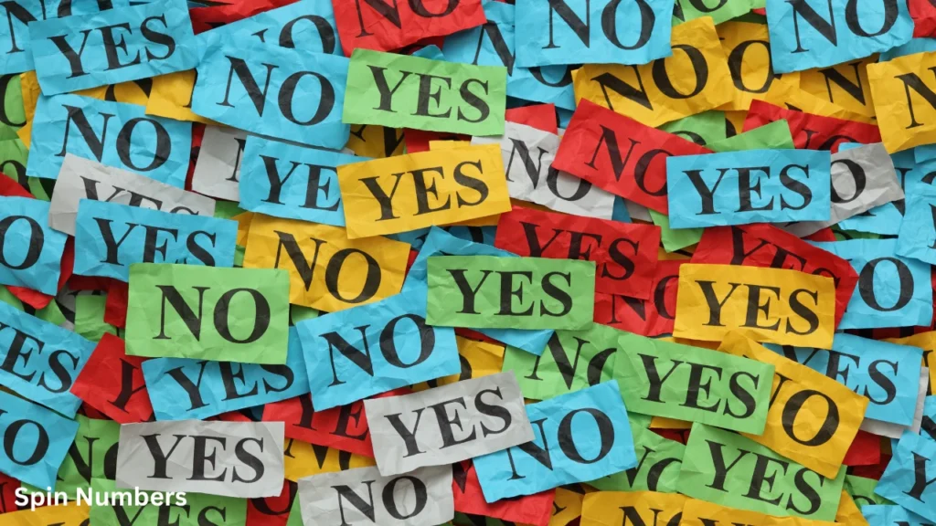 A colorful pile of crumpled paper slips printed with YES and NO options, illustrating binary choices in a Coin Flip vs Yes or No Wheel guide.