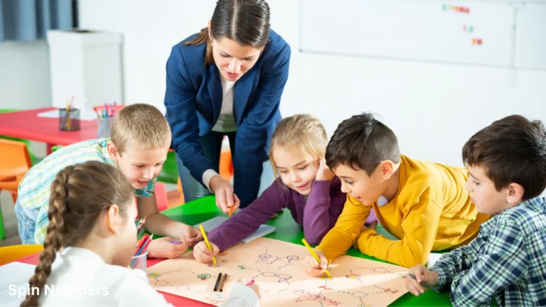An elementary school teacher guiding young pupils as they play custom board games in the classroom.