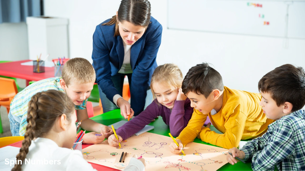 An elementary school teacher guiding young pupils as they play custom board games in the classroom.