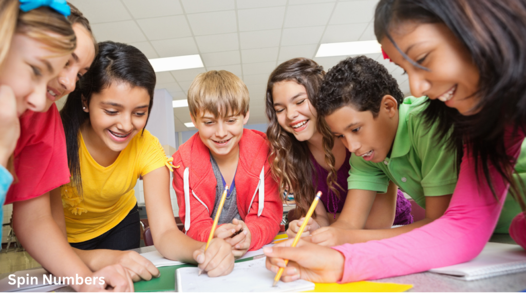 A diverse group of happy students working together on a desk assignment to improve student participation.